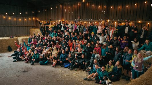 Sisters in the wild summer gathering group shot of all attendees in barn.