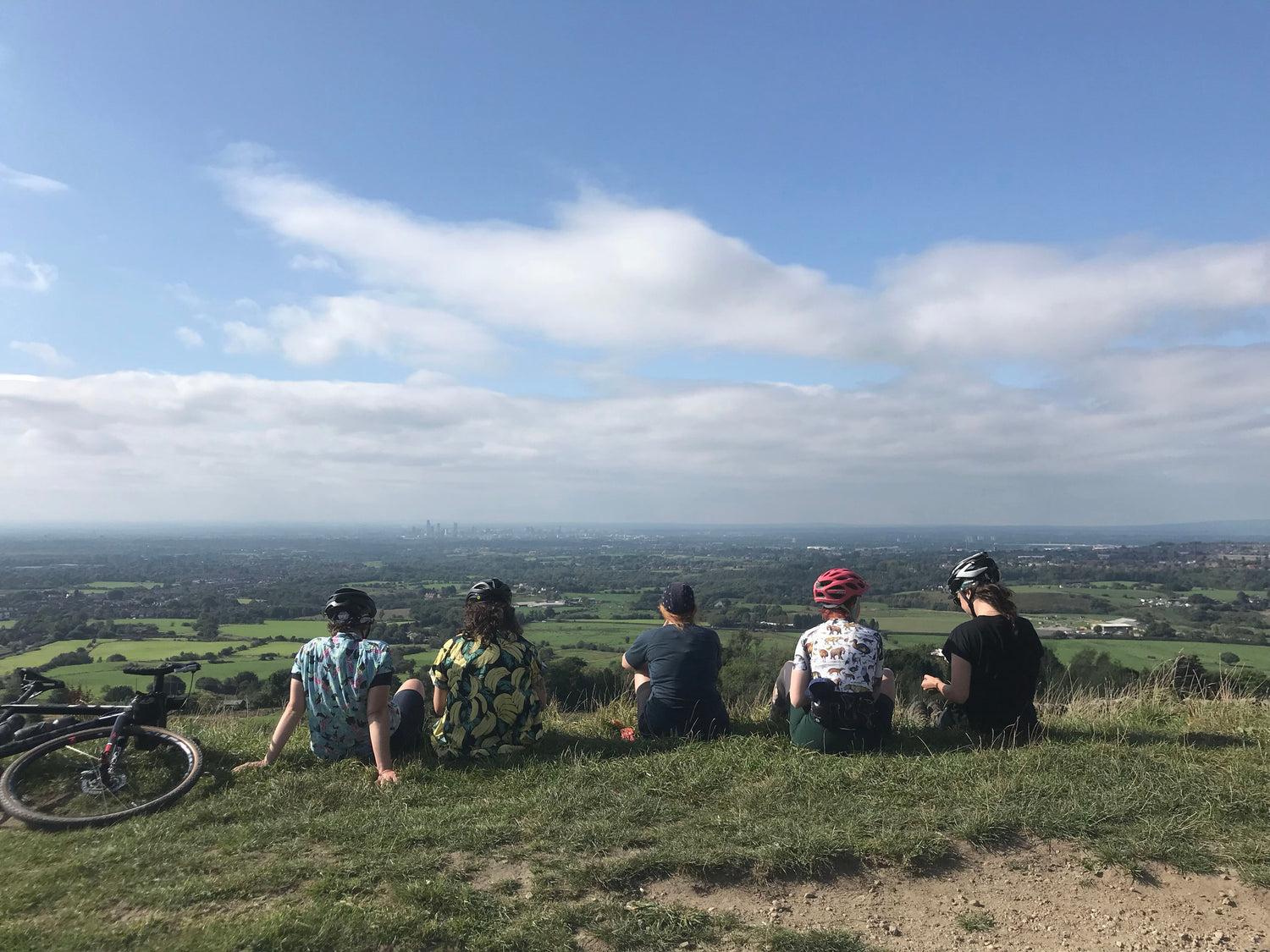 women socialising at the top of a climb on a bike ride on a sunny day