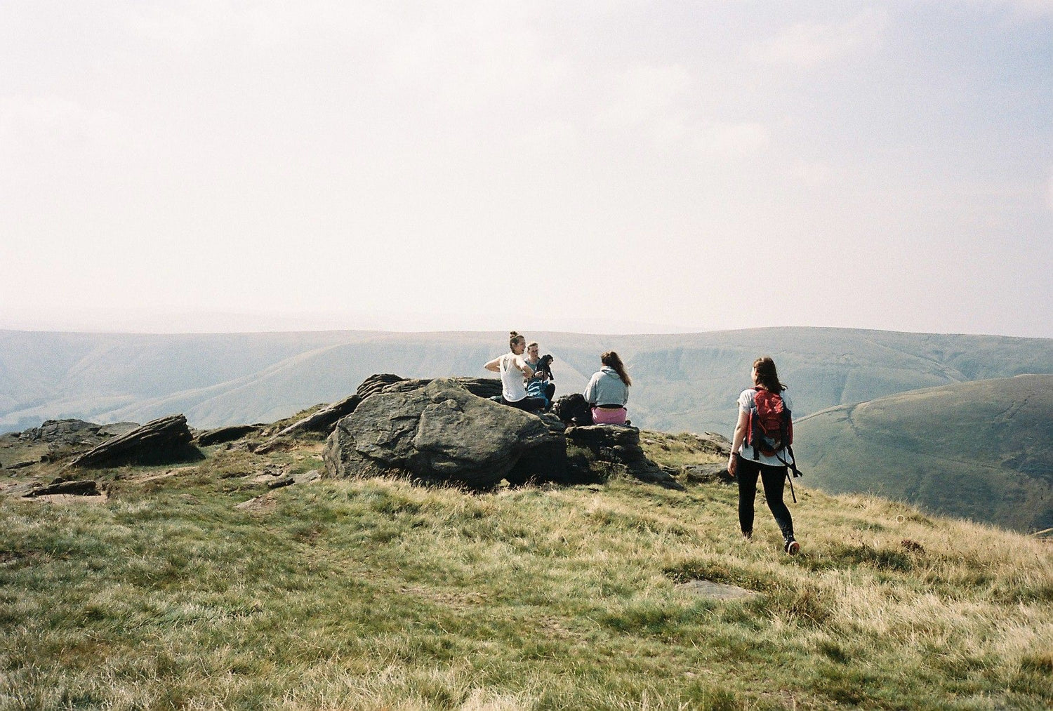 group of women resting on a hike summers day 